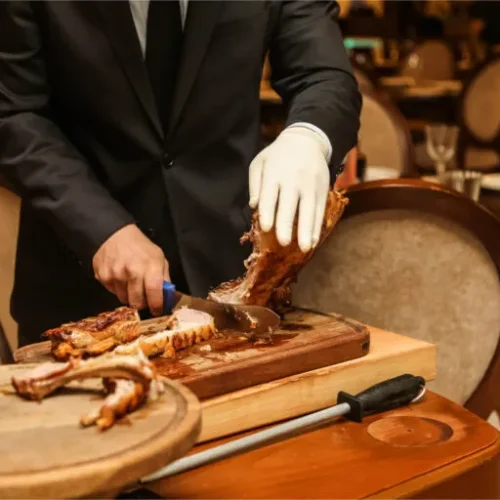 man-separates-meat-from-grilled-ribs-on-the-wooden-2024-10-16-20-13-45-utc-768x512